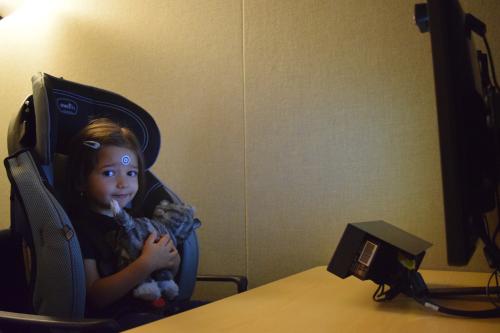 Picture of a toddler in a car seat in our eye-tracking room