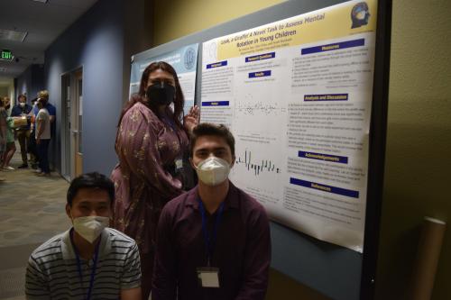 Tyler, Noah, and Ananya standing in front of their poster they presented at the 2022 Undergraduate Research Conference