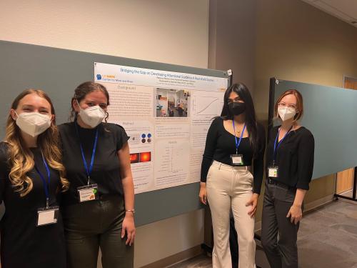 Emily, Becky, Franchesca, and Shannon standing with the poster they presented at the 2022 Undergraduate Research Conference