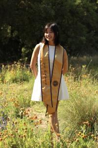Kaitlyn bio picture, white dress standing in field